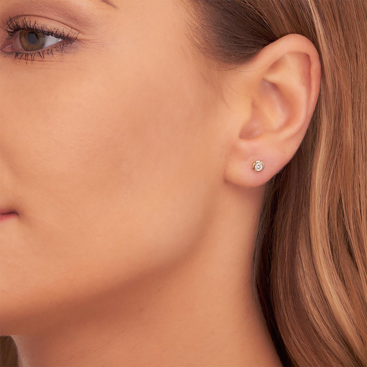 Solitaire 0.20ct Bezel set round diamond studs in 18K yellow gold