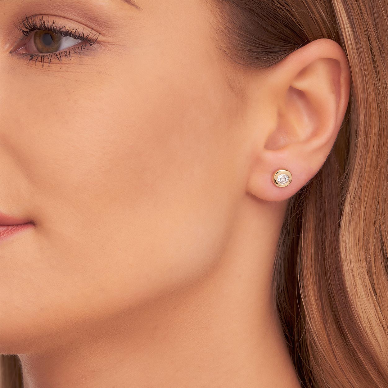 Solitaire 0.50ct Bezel set round diamond studs in 9K yellow gold
