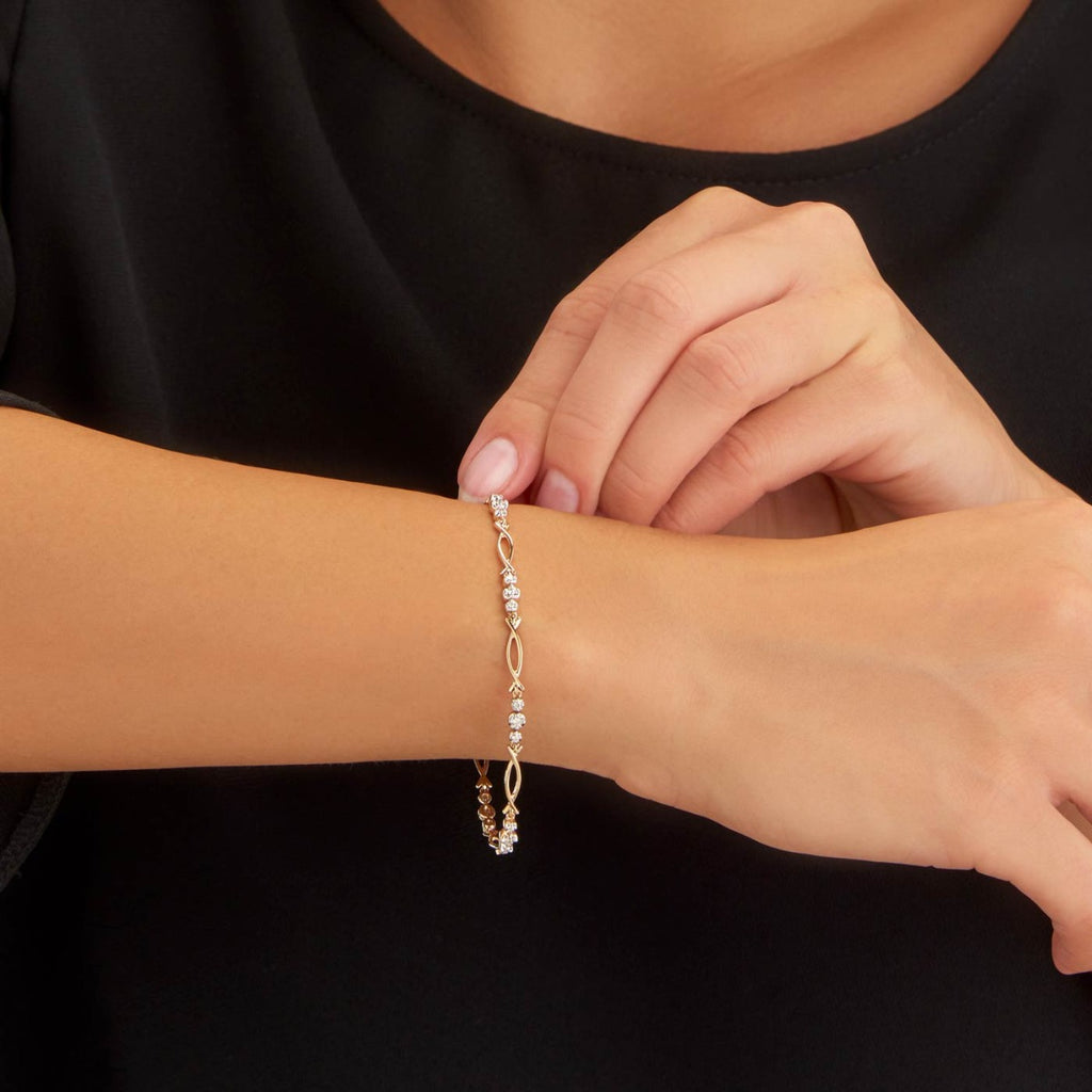 Female Model Wearing Infinity Diamond Bracelet 0.30ct Diamonds in 9K Yellow Gold closeup