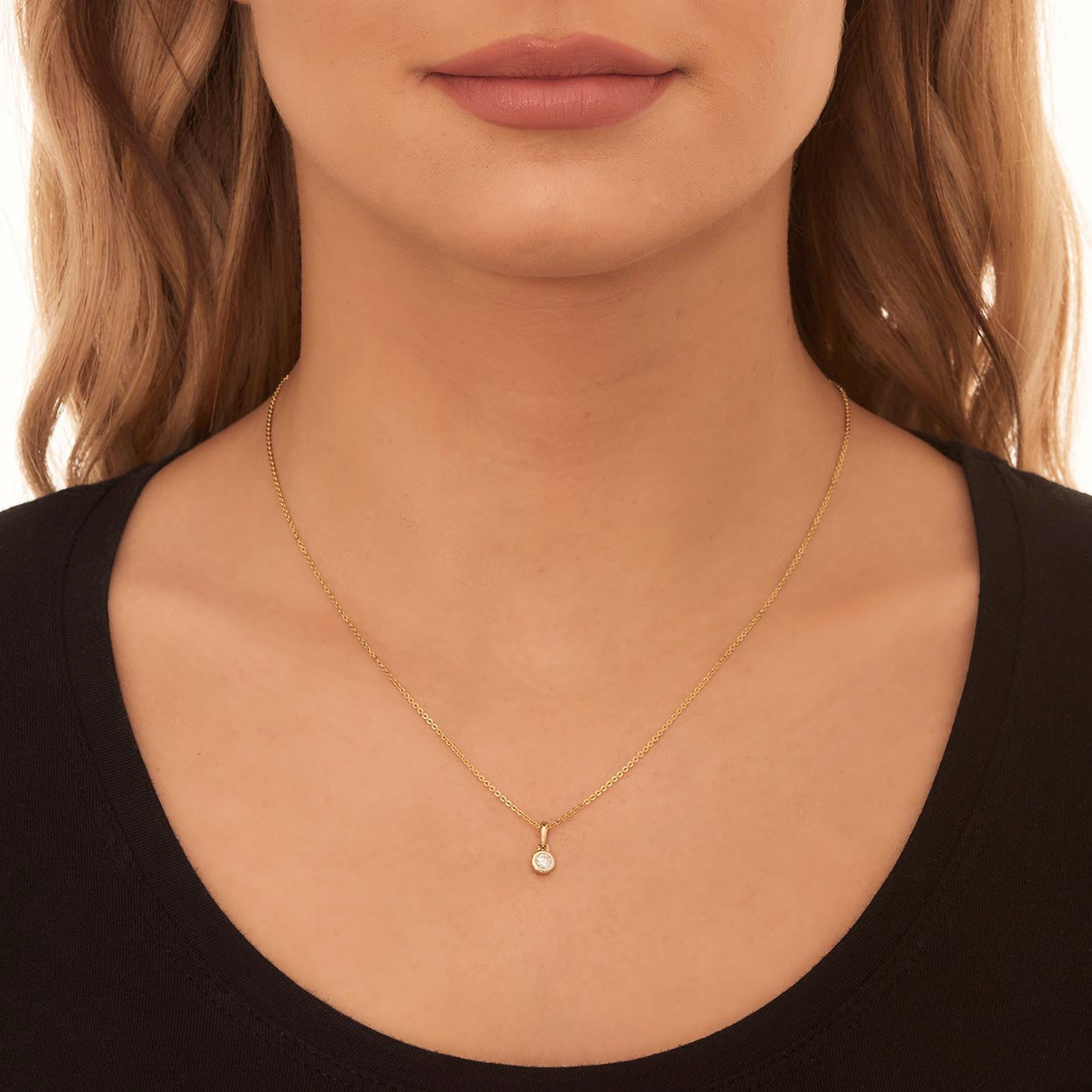 Solitaire 0.20ct bezel set round diamond pendant in 9K yellow gold