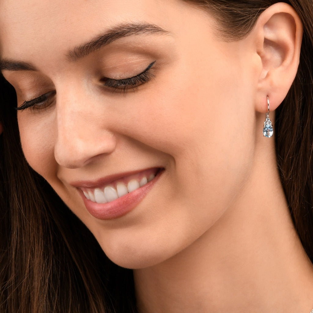 Oval Shaped Blue Topaz Drop Earrings in Sterling Silver