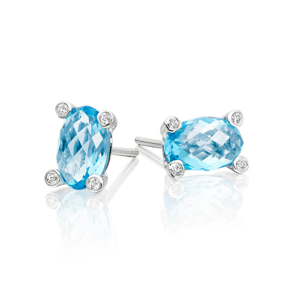 5mm x 8mm Blue Topaz and 0.05ct diamond stud earrings in 9K white gold