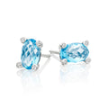 5mm x 8mm Blue Topaz and 0.05ct diamond stud earrings in 9K white gold