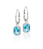 5mm x 7mm Blue Topaz and 0.20ct diamond earrings in 9K white gold