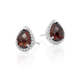 5mm x 7mm Garnet and 0.16ct diamond stud earrings in 9K white gold
