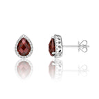 5mm x 7mm Garnet and 0.16ct diamond stud earrings in 9K white gold