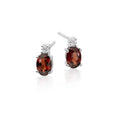 5mm x 7mm Garnet and 0.07ct diamond stud earrings in 18K white gold