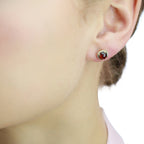 6mm Garnet and 0.12ct diamond stud earrings in 18K yellow gold