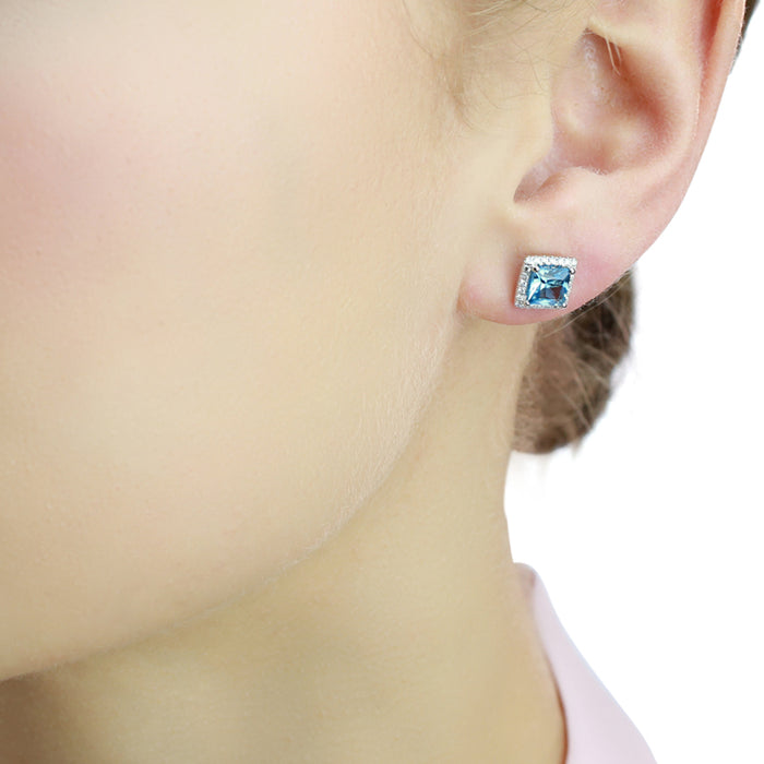 1.80ct Blue Topaz And 0.19ct Diamond Stud Earrings In 9K White Gold