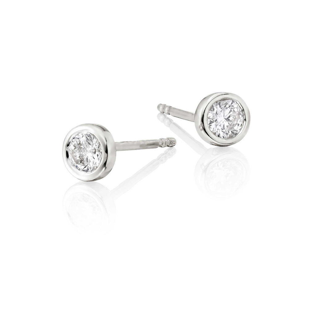Solitaire 0.30ct bezel set round diamond studs in 18K white gold