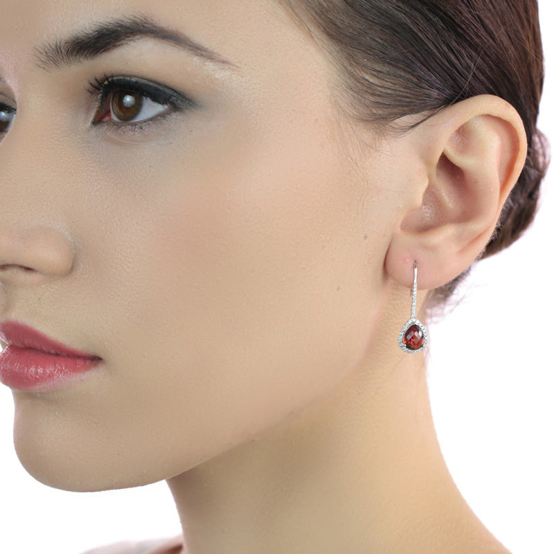 7mm x 9mm Garnet and 0.33ct diamond earrings in 18K white gold
