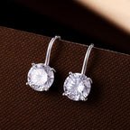 Sterling Silver Zirconia Drop Earrings 8mm Round Zirconia on brown surface