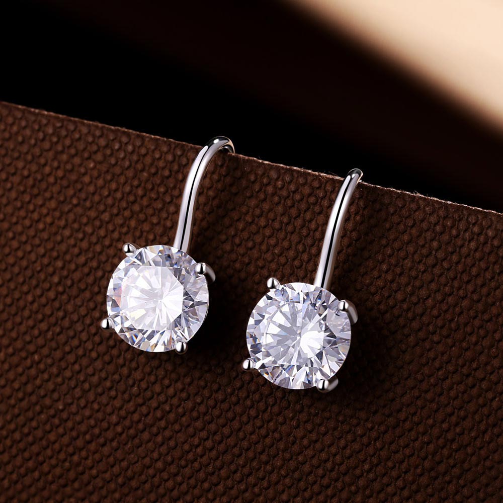 Sterling Silver Zirconia Drop Earrings 8mm Round Zirconia on brown surface